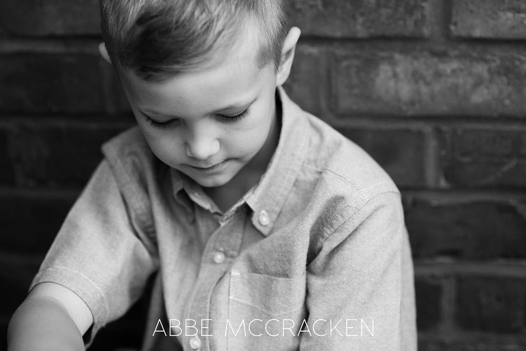 Black and white close up of a reflective young boy
