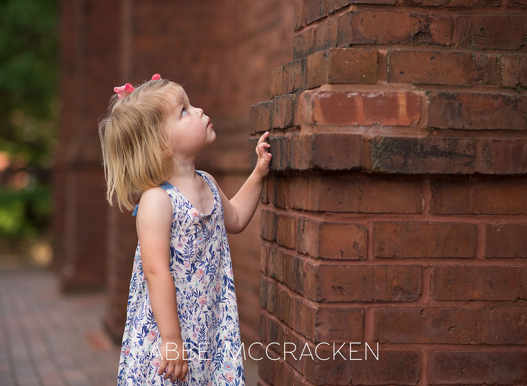 Little girl looking to the top of a church in Uptown Charlotte