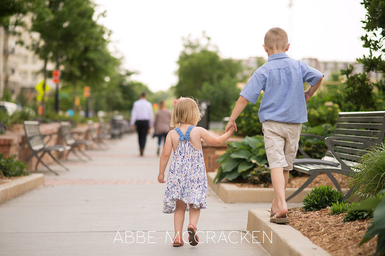 Siblings walking hand-in-hand to Romare Bearden Park in Charlotte, NC
