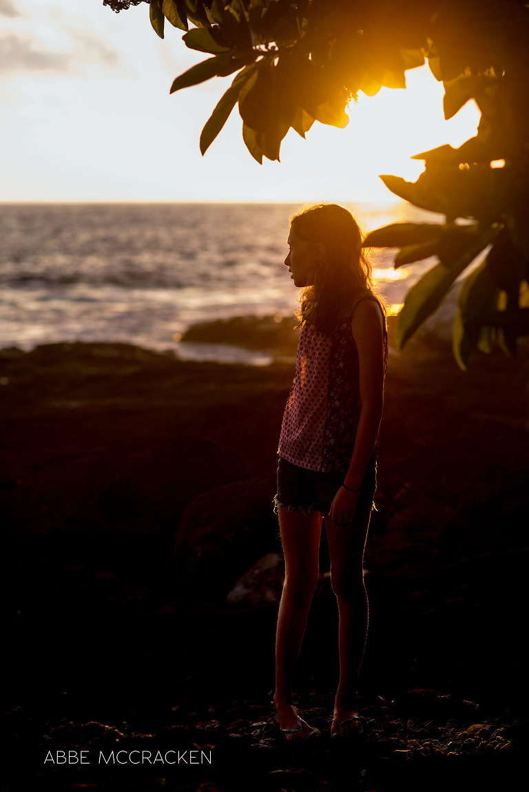 vacation photos with gorgeous rim light - Charlotte photographer Abbe McCracken's daughter enjoying a Hawaiian sunset