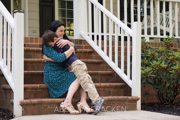 Summer family photography session - son hugging mom on their front steps