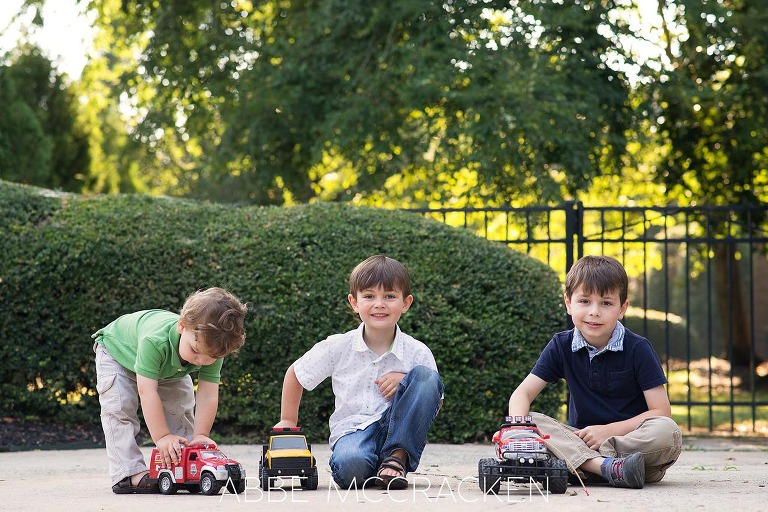 Summer family photography session at home - 3 boys in the driveway with trucks