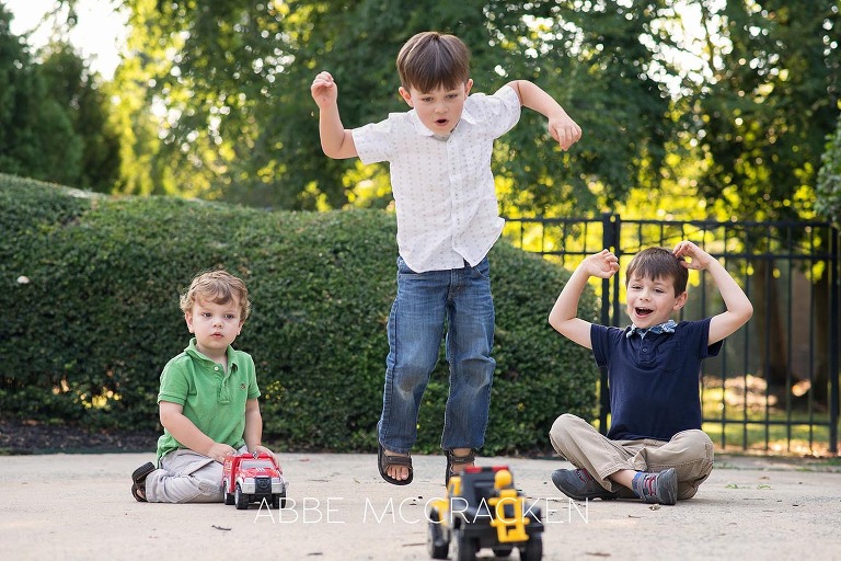 Summer family photography session at home - 3 boys in the driveway with trucks