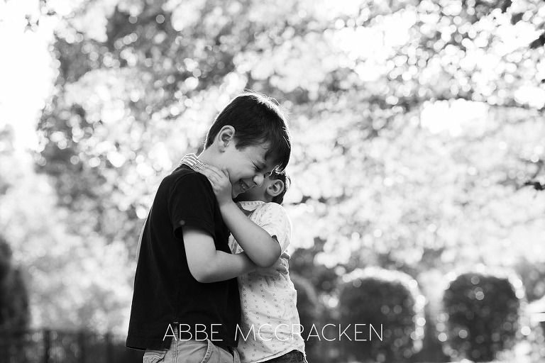 Summer family photography session at home - brothers laughing at each other