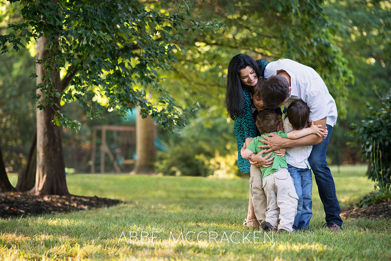 Family hug during a summer family photo session at home