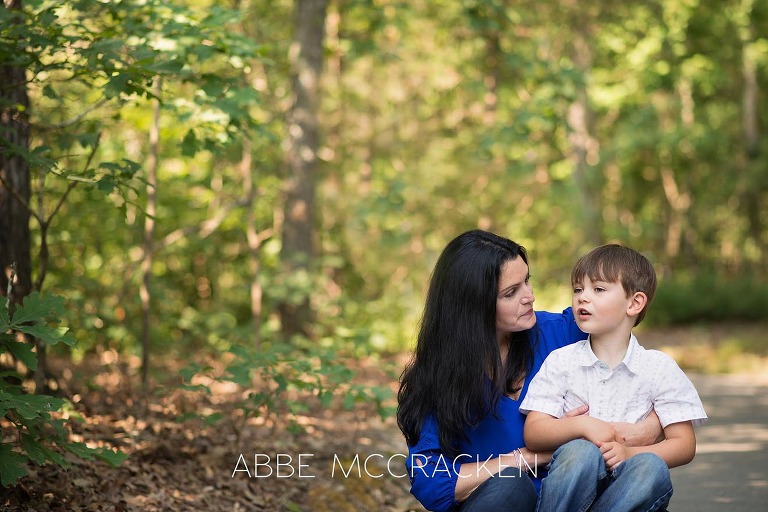 Mother and son talking during a summer family photography session at Squirrel Lake Park in Matthews, NC