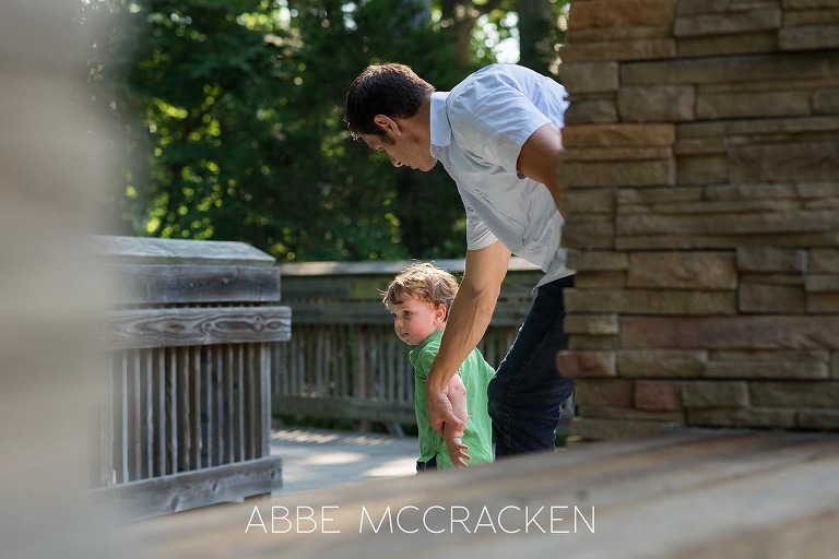 Portrait of parenthood - father chasing toddler - at Squirrel Lake Park in Matthews, NC