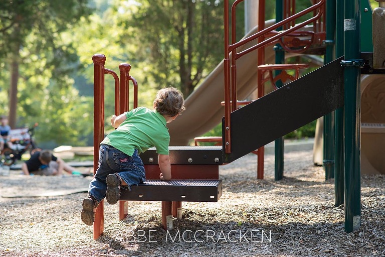 Candid image of a toddler playing at Squirrel Lake Park in Matthews, NC - July 2016