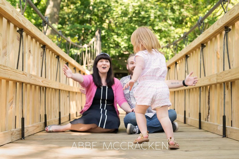 candid family pictures in Charlotte's Freedom Park with a two year old