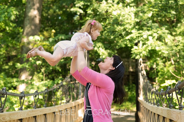 Candid mother-daughter image in Charlotte NC's Freedom Park - family portraits