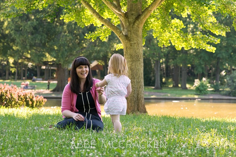 Candid mother-daughter image in Charlotte NC's Freedom Park - family portraits