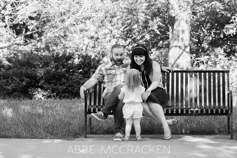 Black and white, candid portrait of a young family in Charlotte's Freedom Park