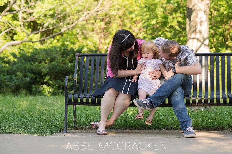 candid portrait of a young family in Charlotte's Freedom Park