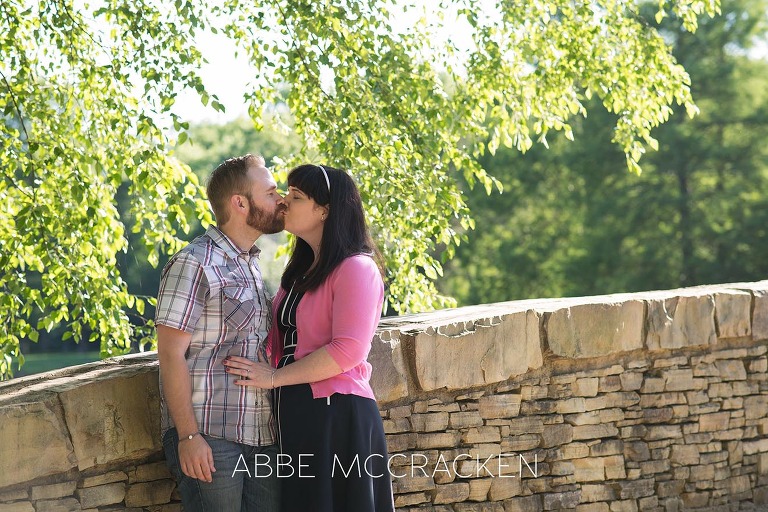 couple kissing photographed during spring family pictures in Charlotte's Freedom Park