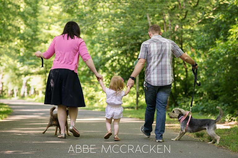 Family of five - 3 humans, 2 dogs - walking on a paved trail in Charlotte NC's Freedom Park