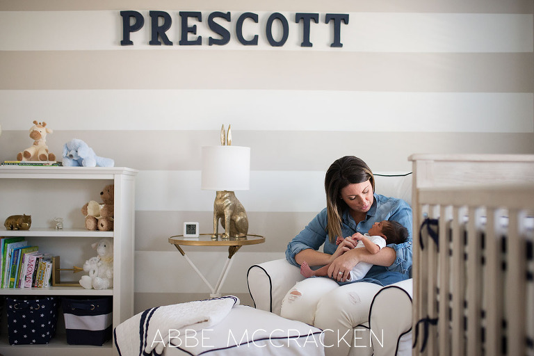 Mother and newborn baby son snuggling in his stylish nursery