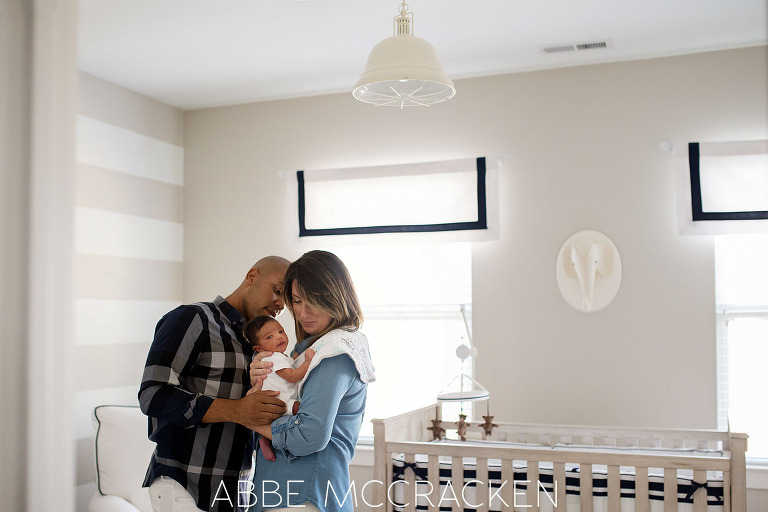 Newborn baby boy checking out the photographer during an in-home newborn lifestyle session in Pineville, NC