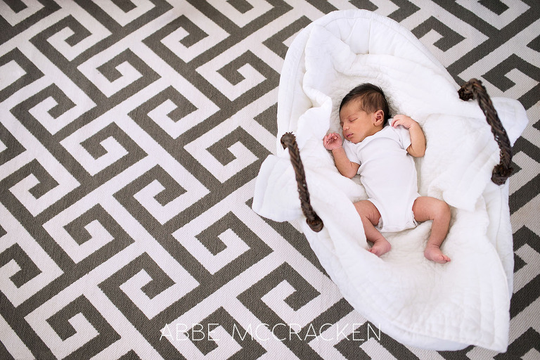 Pineville newborn sleeping in bassinet at home during his newborn photography session