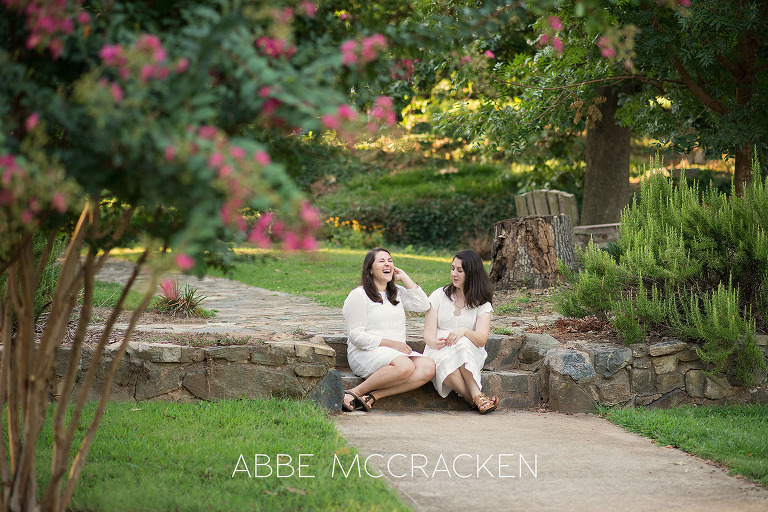 Candid portrait of adult sisters laughing in Charlotte's Independence Park