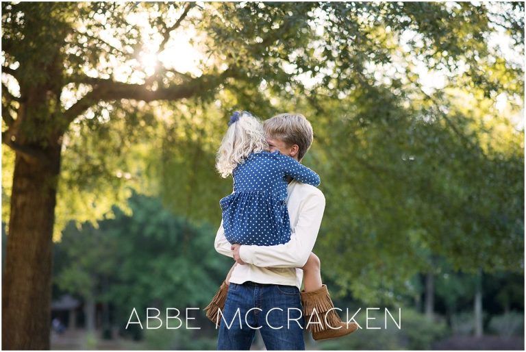 Image of big brother hugging little sister - family photography in Charlotte's Freedom Park