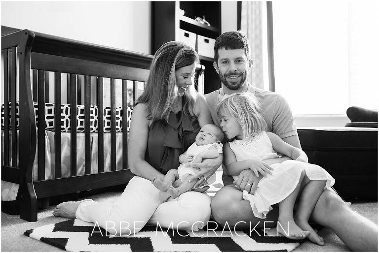 Newborn lifestyle photography session - family portrait in the nursery