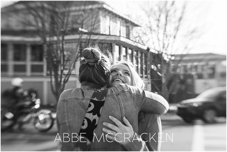 A high school senior's aunt stops by her senior portrait session for a hug