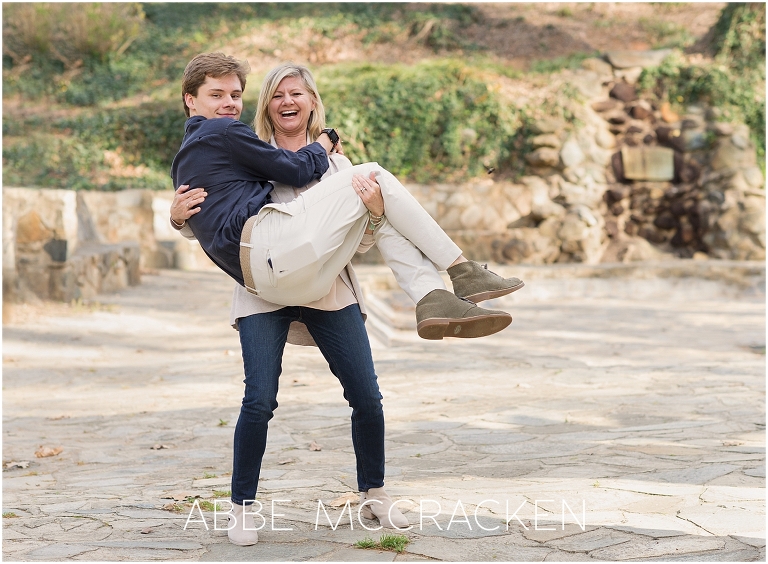 Mother holding her oldest son and laughing - photographed during a family session in Charlotte NC