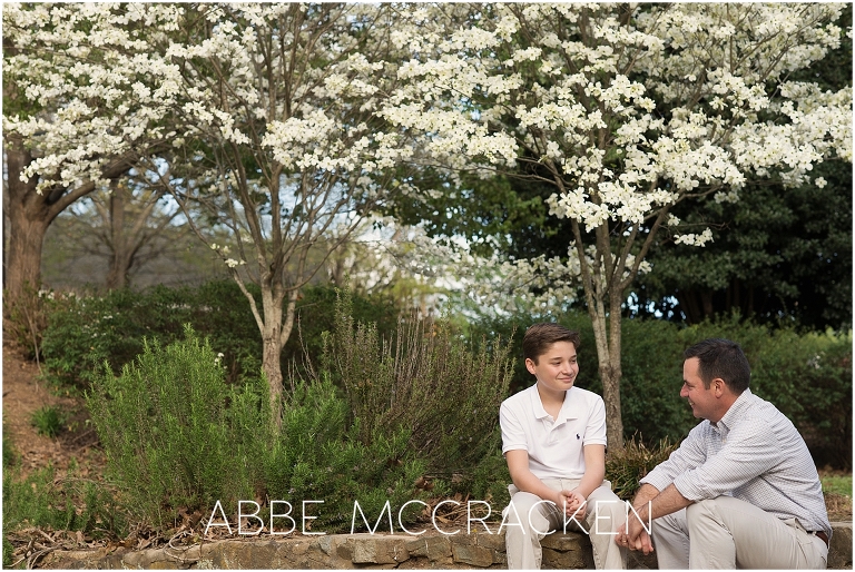 Father and youngest son enjoy a quiet moment during a family photography session in Charlotte's Independence Park