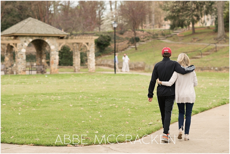 Image of mother and her high school graduate walking towards their family in Independence Park, Charlotte NC