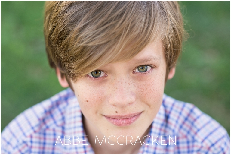 Young tween boy with green eyes and freckles