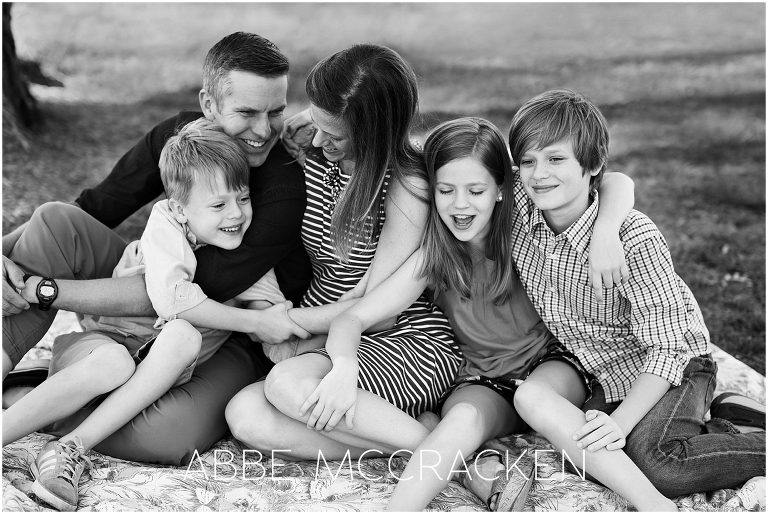 Black and white candid family portrait photographed in Charlotte's Freedom Park