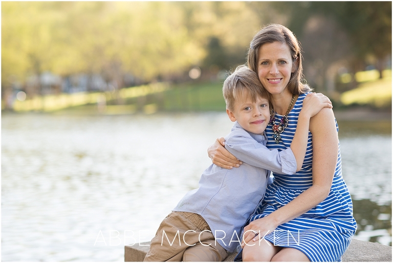 Picture of a mother and her youngest son snuggling near the pond in Charlotte's Freedom Park