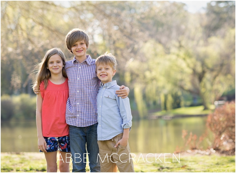 Three siblings posing for a picture during a family photography session in Charlotte's Freedom Park