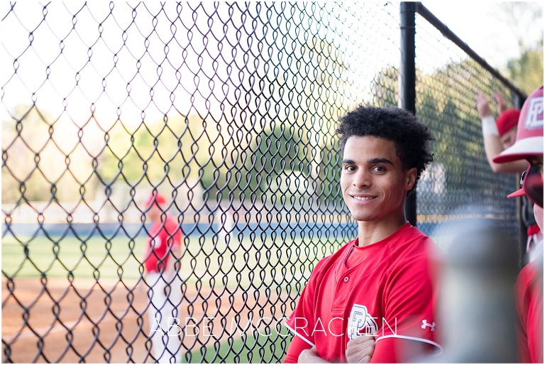 Dugout portrait of high school senior during his baseball game