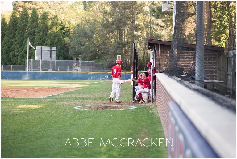 Candid dugout image of teamwork and camaraderie during high school baseball game