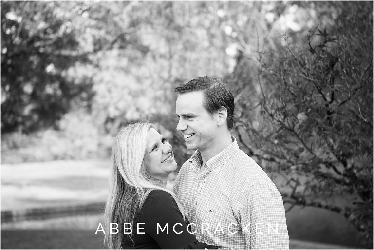 Candid black and white image of husband and wife laughing