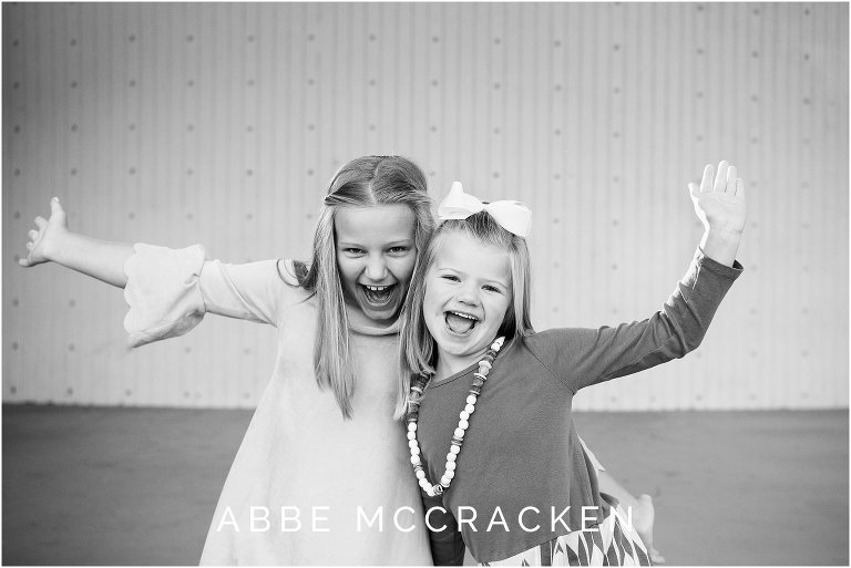 Candid, playful image of sisters photographed in Freedom Park's amphitheater