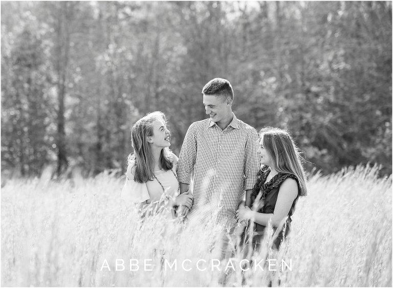 black and white candid image of siblings laughing