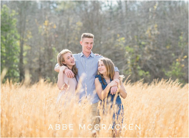 warm, sunny spring picture of siblings in a wheat field