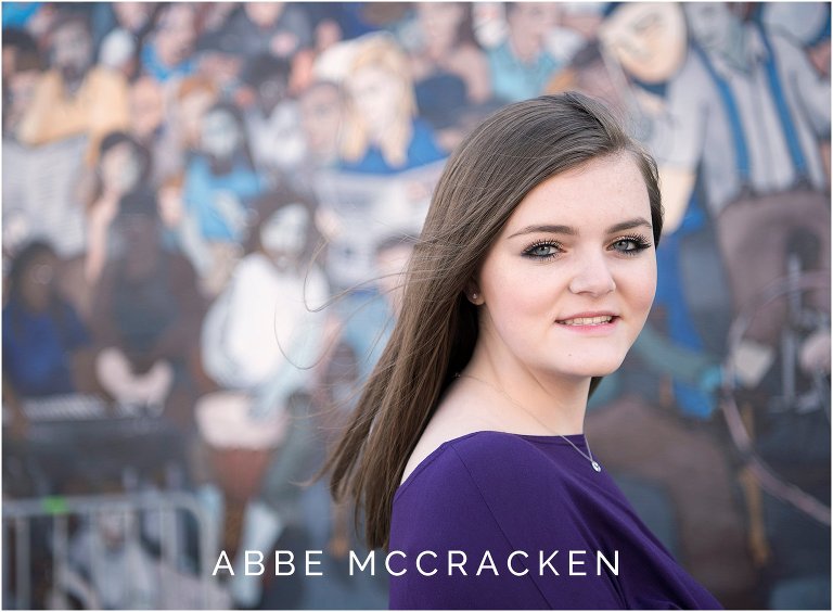 Spring senior portraits with NoDa's funky colorful walls in the background