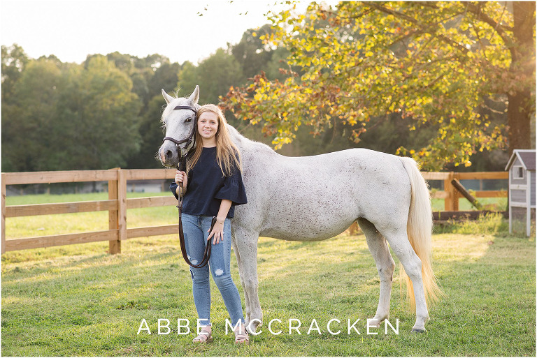 Senior portrait with a horse, photographed on a family farm south of Charlotte, NC