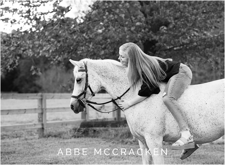 Senior portrait with a white horse