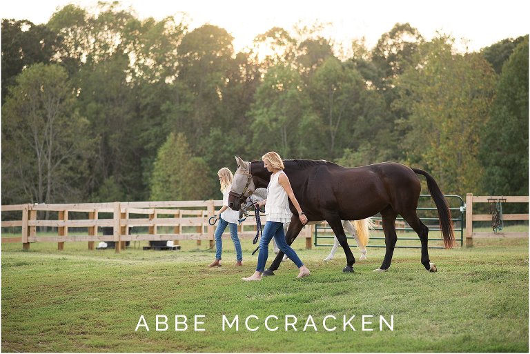 Family members walking horses at sunset. Photographed at Old Frankfort Farm and Stables.