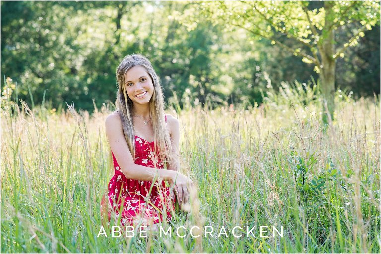 Colorful senior portrait in wheat fields, tall spring grasses