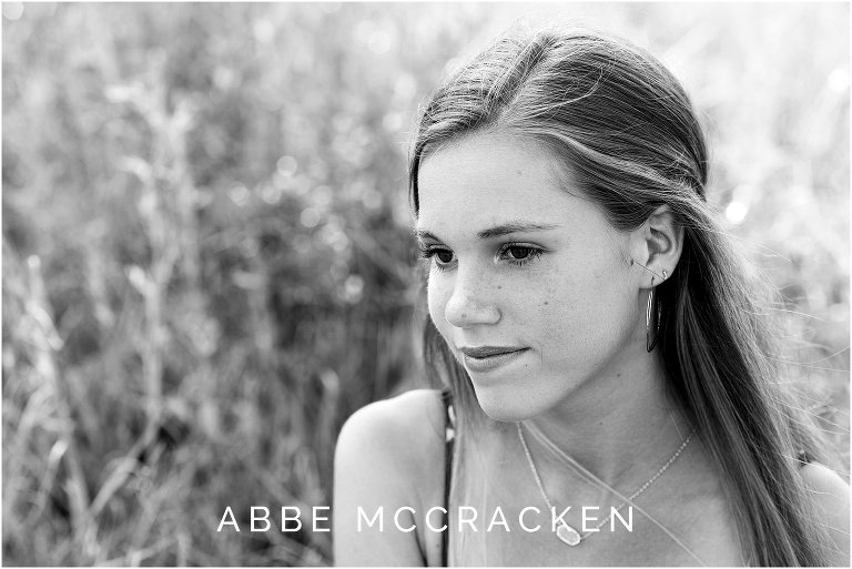 black and white close up image of gorgeous senior girl with long blonde hair and freckles