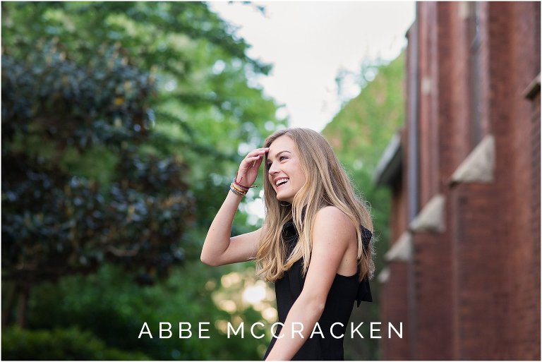 Candid senior portrait of beautiful blonde girl laughing in uptown Charlotte NC