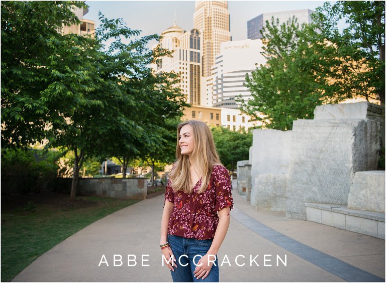 Urban senior pictures with Charlotte NC skyline in the background