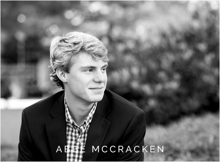 Candid black and white portrait of a high school senior guy