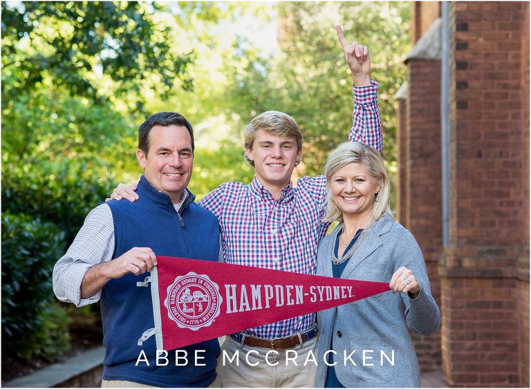 Charlotte Catholic senior and his parents hold up a Hampden-Sydney pendant