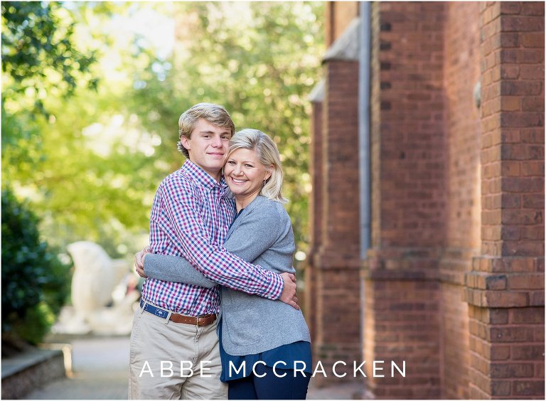 senior portrait of a boy hugging his mom